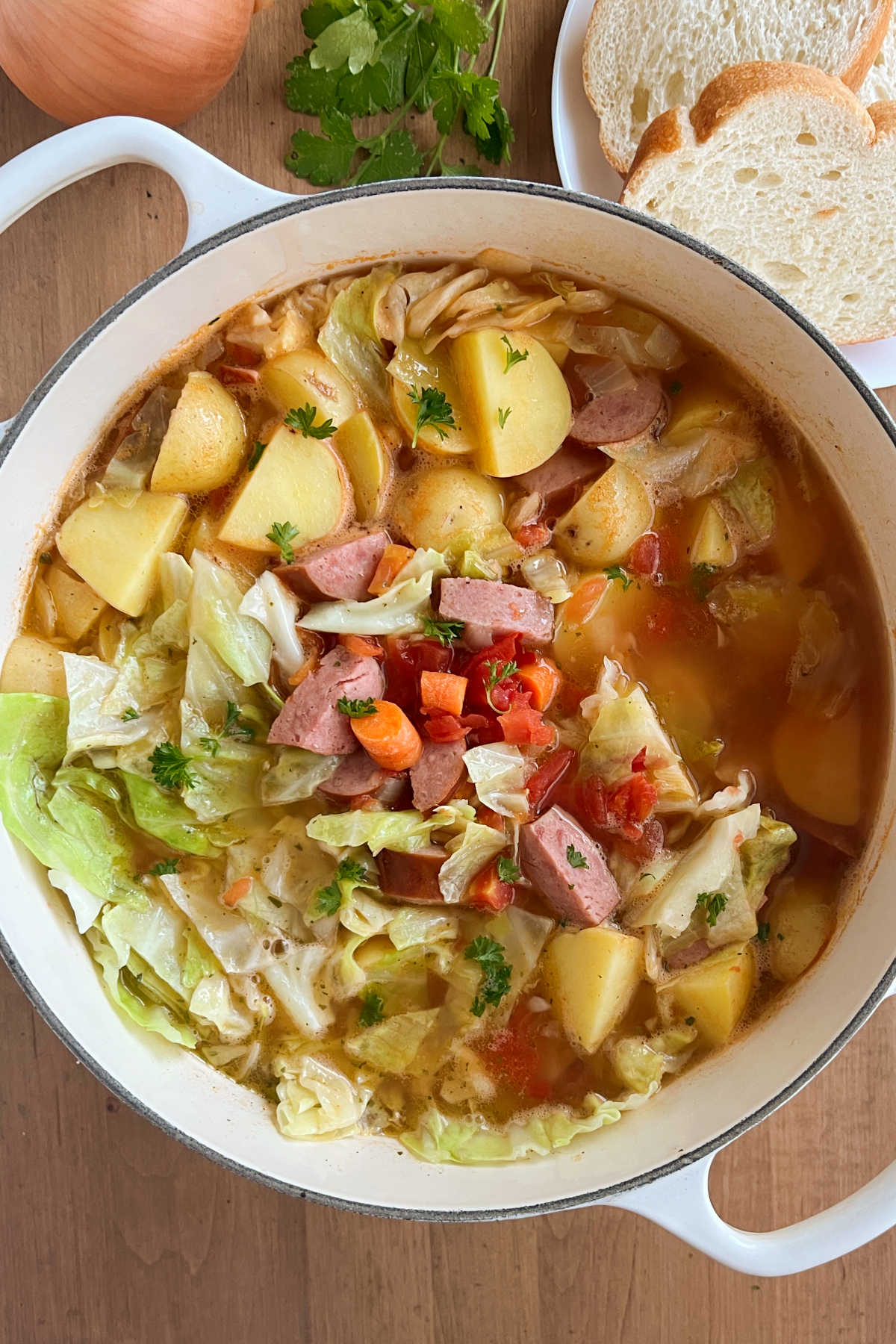 cabbage soup with kielbasa sausage carrots and potatoes in dutch oven