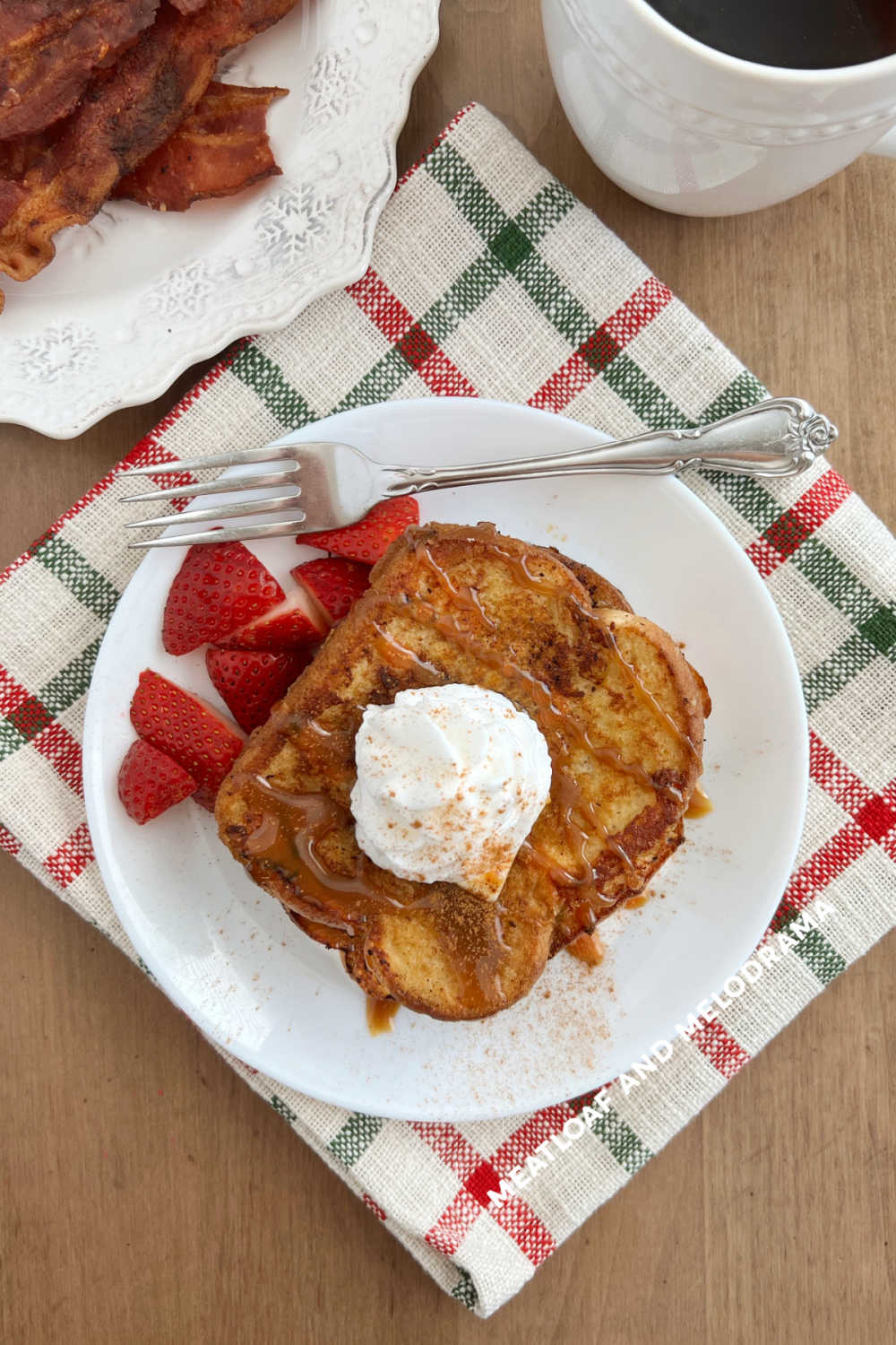 eggnog french toast with crispy bacon and cup of coffee on table