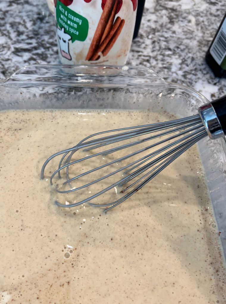 whisk eggnog with eggs in baking dish
