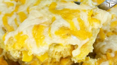 jiffy corn casserole (corn pudding) with cheese on serving spoon