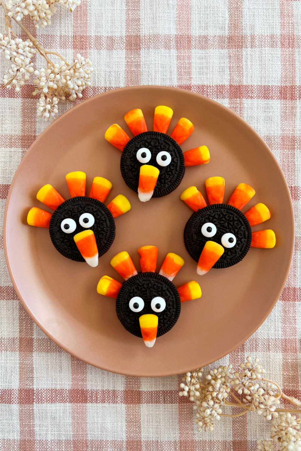 Oreo turkey cookies with Oreos and candy corn on Thanksgiving table