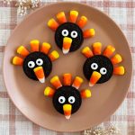 oreo turkey cookies with oreos and candy corn on a plate