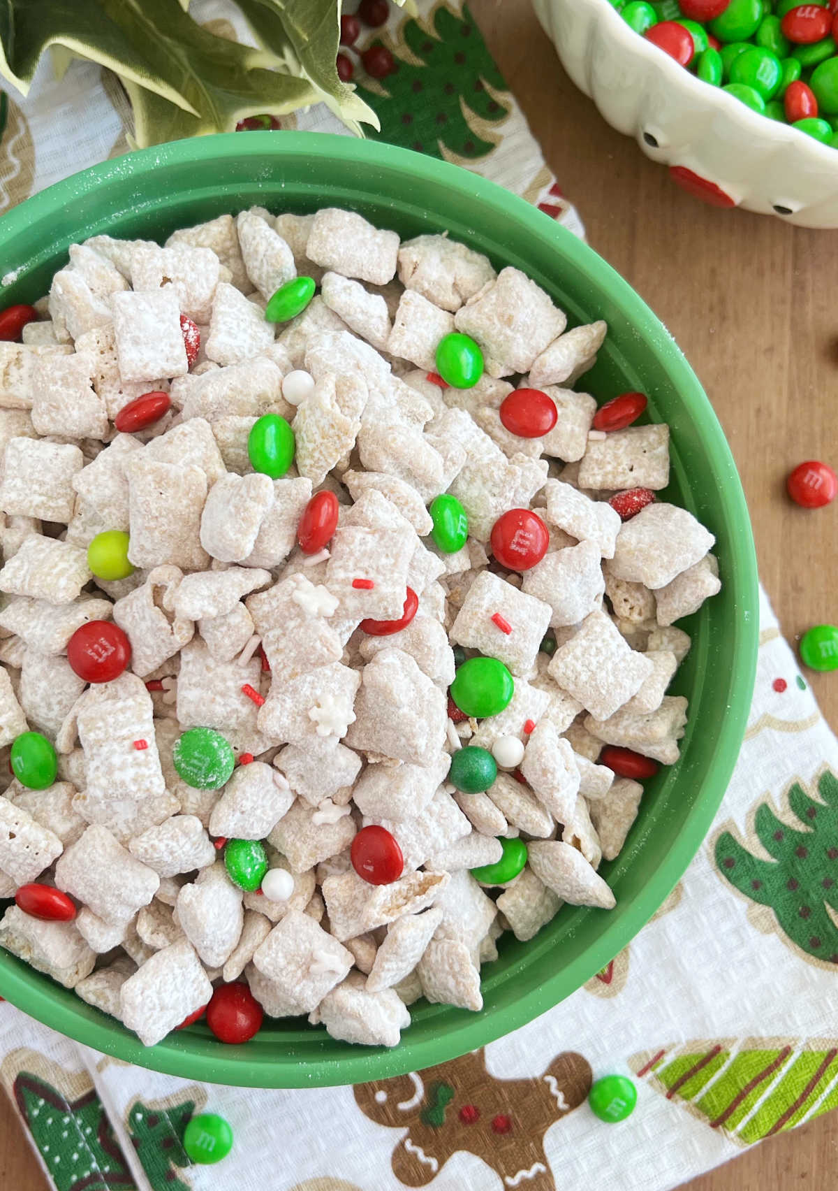 white chocolate puppy chow (muddy buddies) with red and green candy in bowl