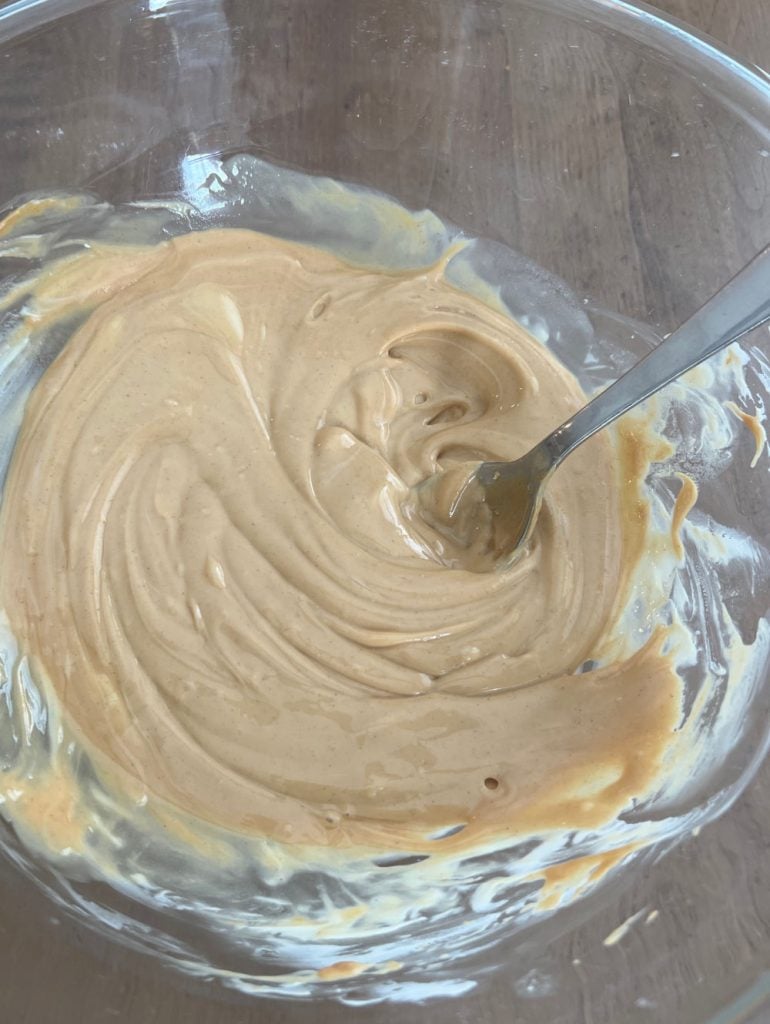 stir melted white chocolate and peanut butter mixture in mixing bowl