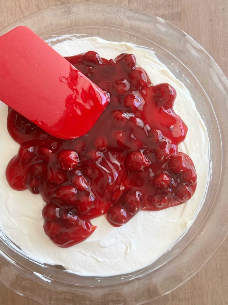 spread cherry pie filling over cheesecake mixture
