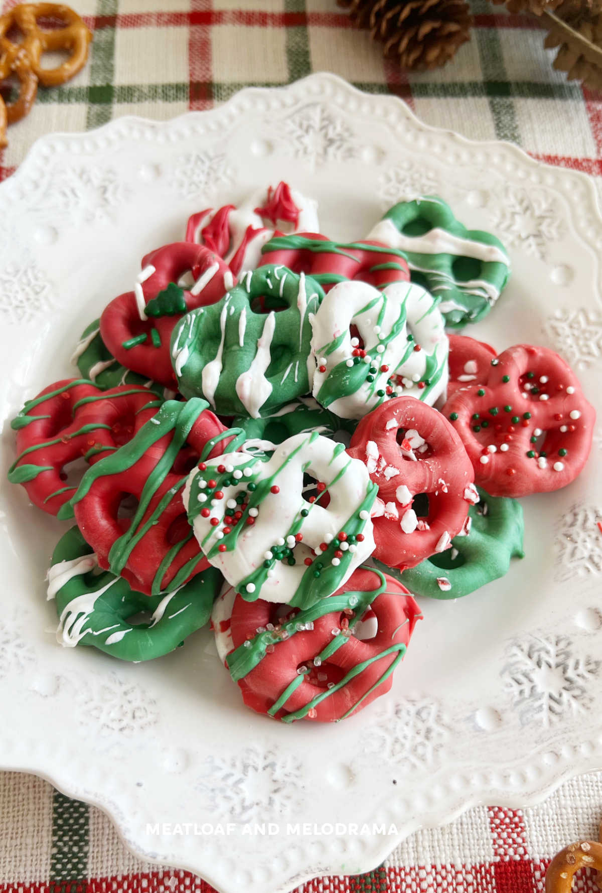 plate of chocolate dipped christmas pretzels with sprinkles