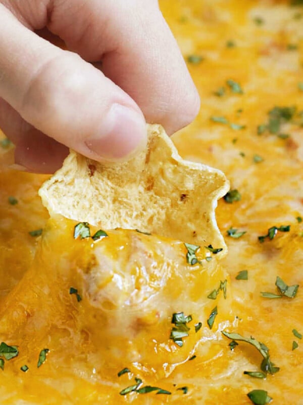 cream cheese bean dip with cheddar cheese on tostitos scoop tortilla chip