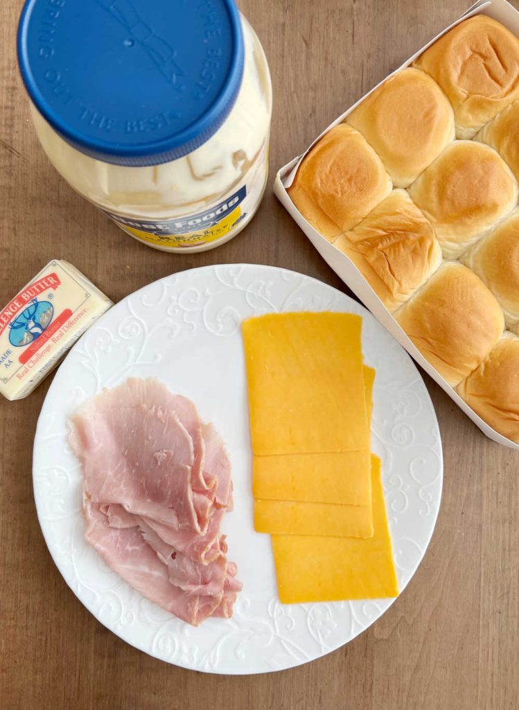 spiral ham slices, cheddar cheese slices, butter, mayonnaise and soft rolls