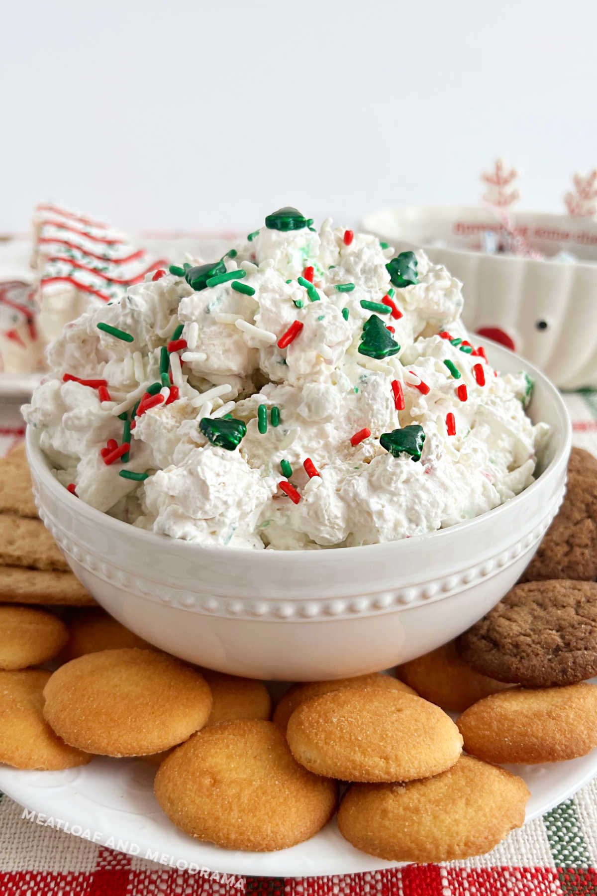 little Debbie Christmas tree cake dip with holiday sprinkles and dippers on a platter