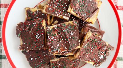 saltine toffee with melted chocolate and sprinkles on a plate