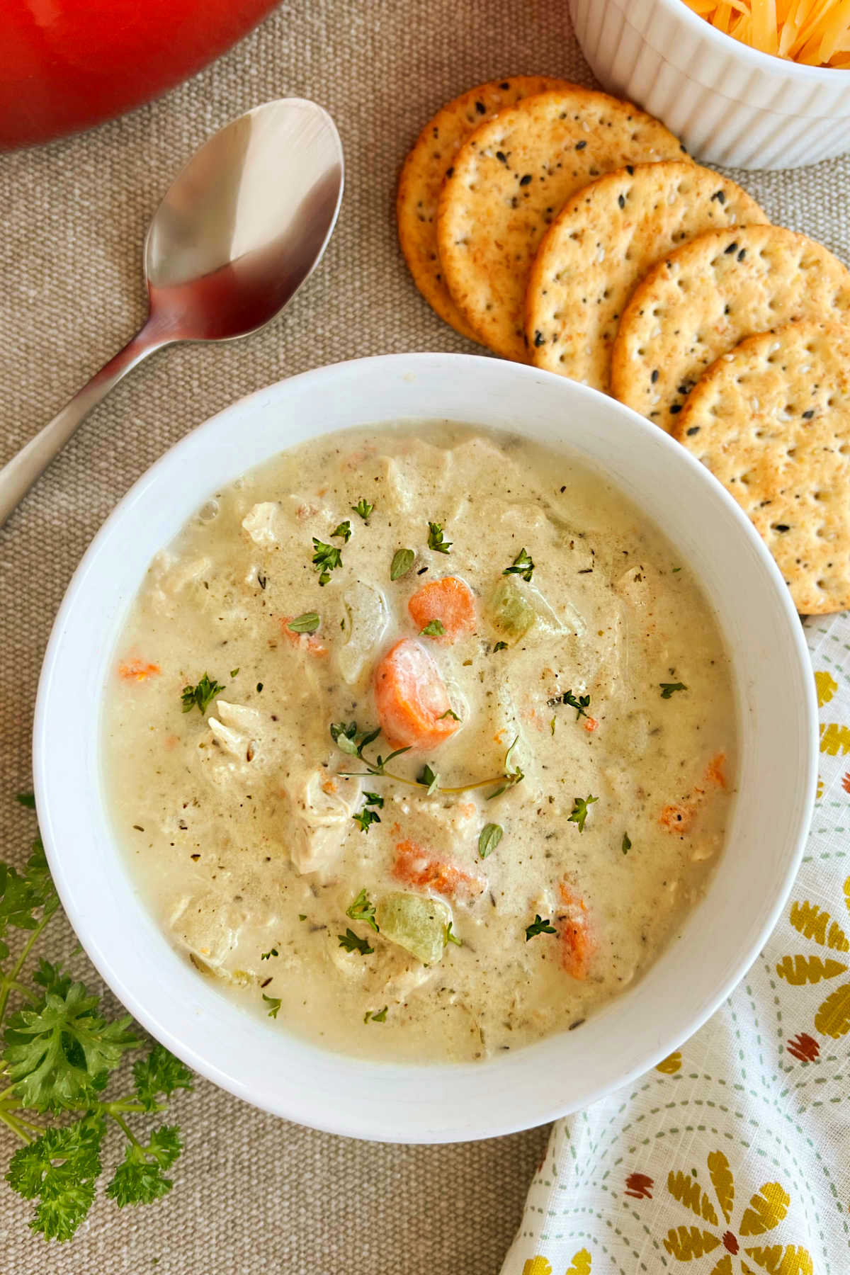 bowl of creamy chicken and potato soup with crackers