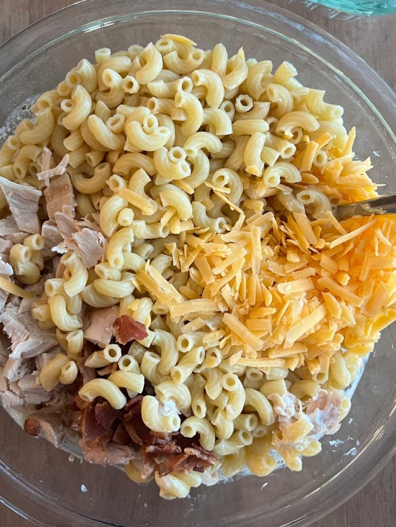mix cooked pasta, cheese, bacon and chicken in large bowl