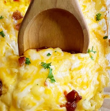 crack chicken casserole recipe with cheddar cheese and bacon on a serving spoon