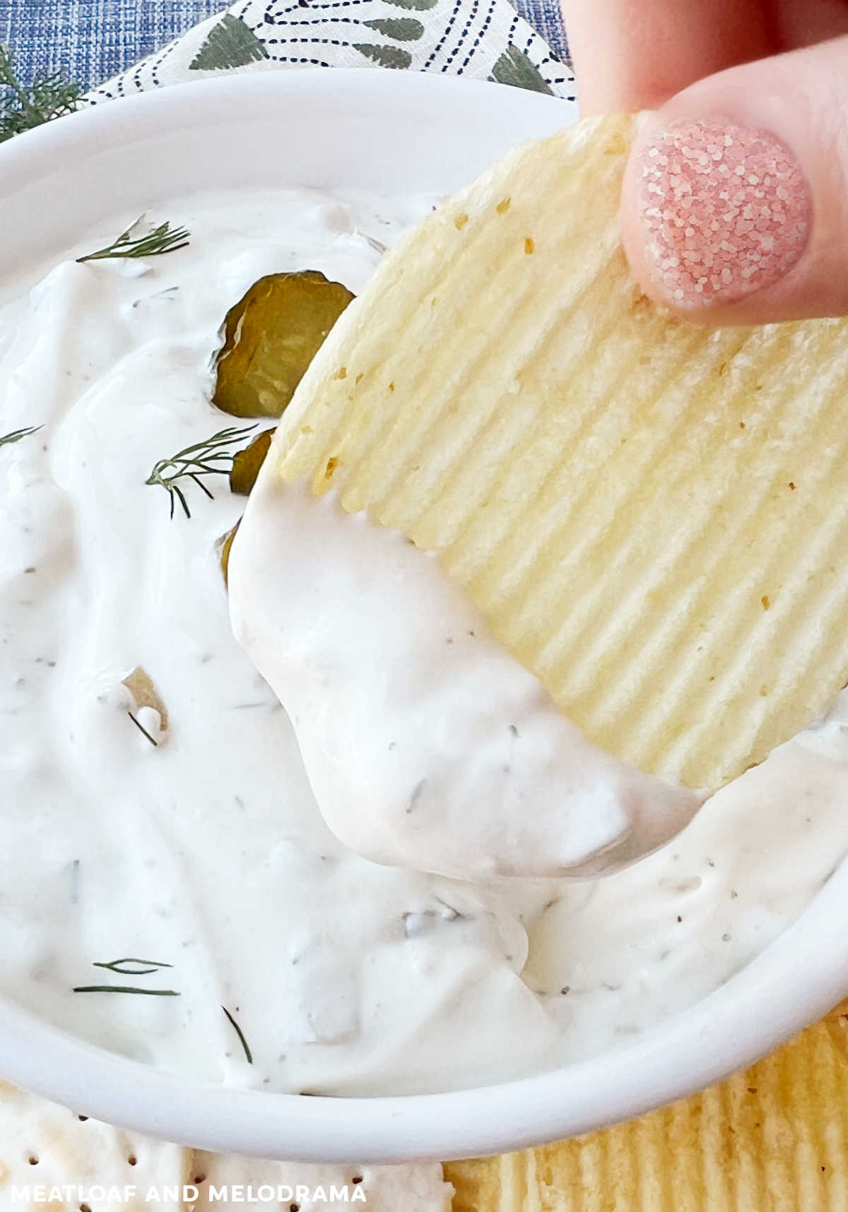 dip potato chip into creamy dill pickle dip