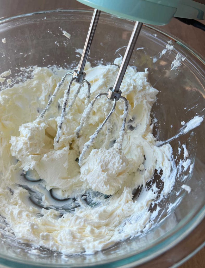 blend cream cheese and sour cream in mixing bowl with electric mixer