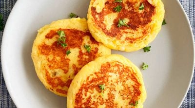 leftover mashed potato cakes (potato patties) on a plate with parsley