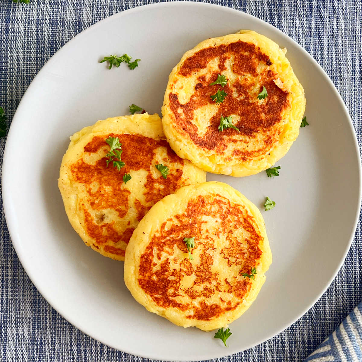 leftover mashed potato cakes (potato patties) on a plate with parsley