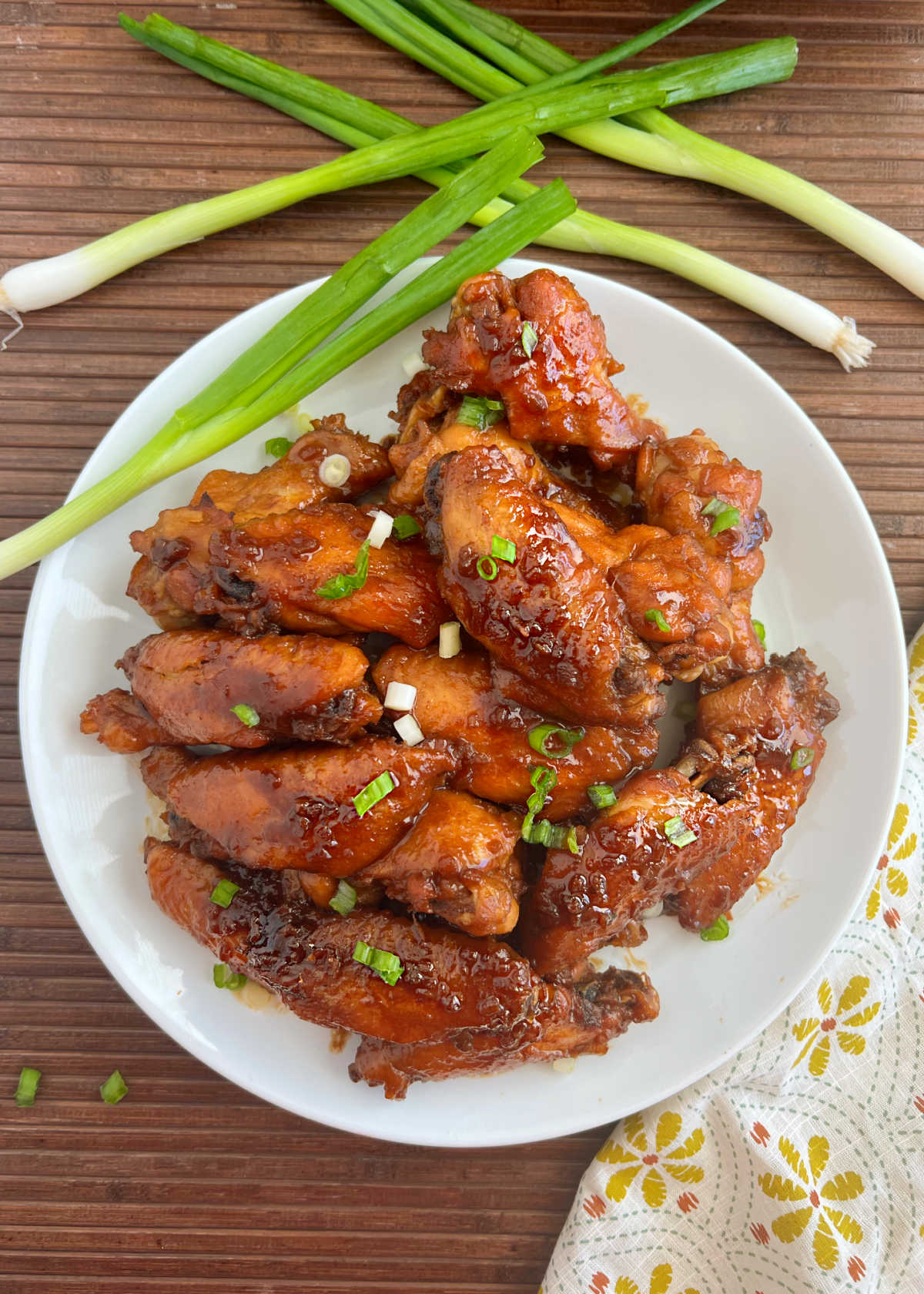 teriyaki wings with green onions on table