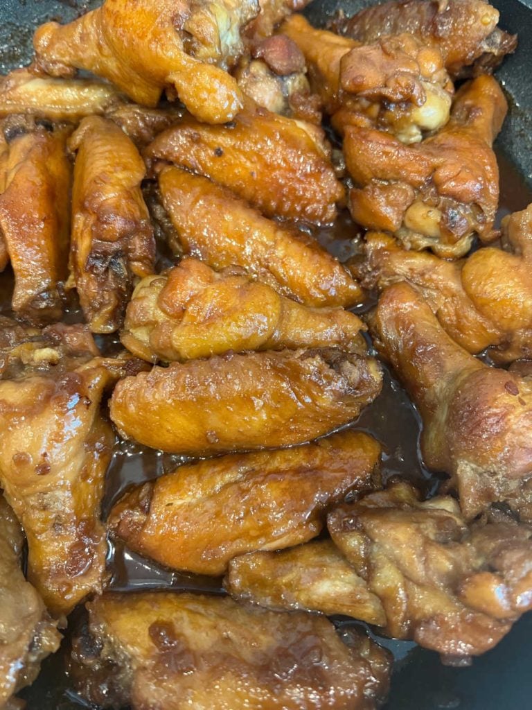 cook chicken wings in soy sauce mixture in skillet