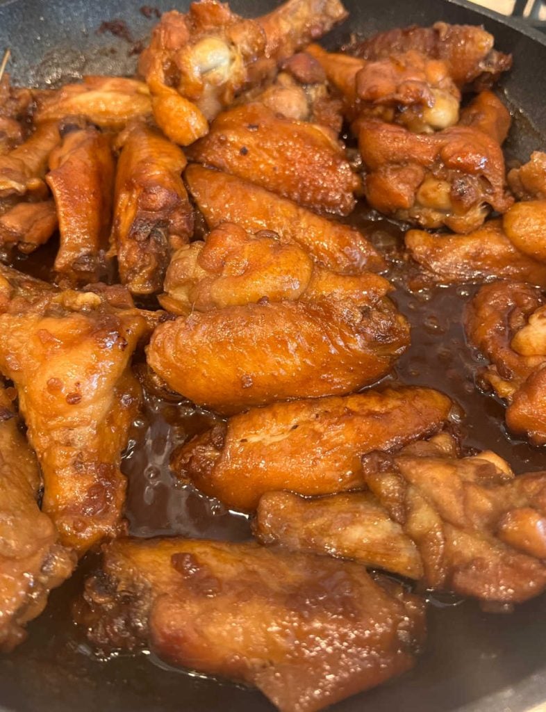wings in teriyaki sauce in skillet