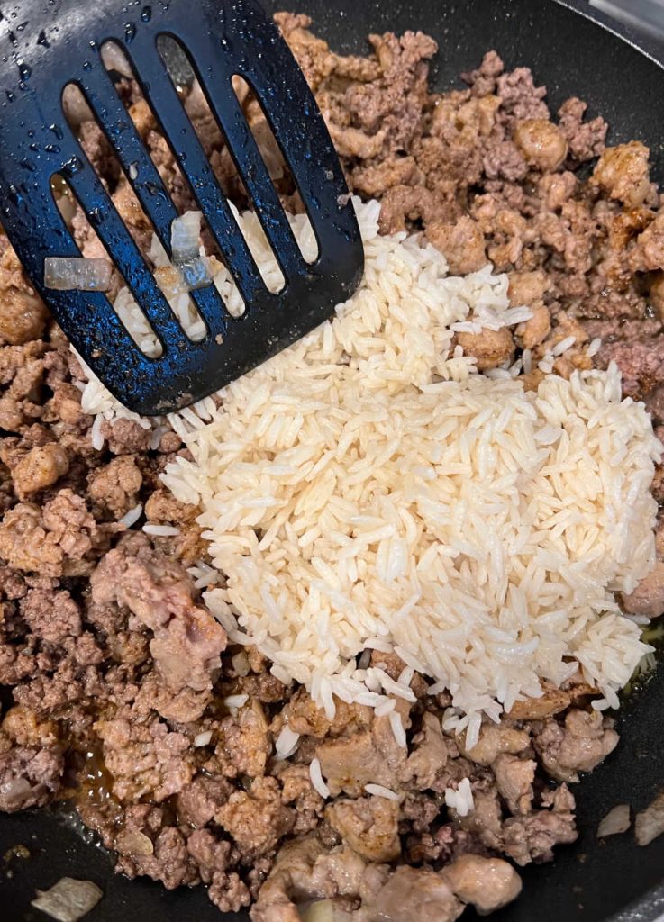 cook ground beef and sausage with white rice in skillet