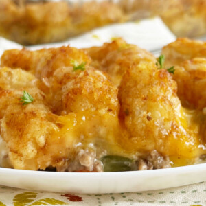 cheesy tater tot casserole with hamburger meat and melted cheese on a plate