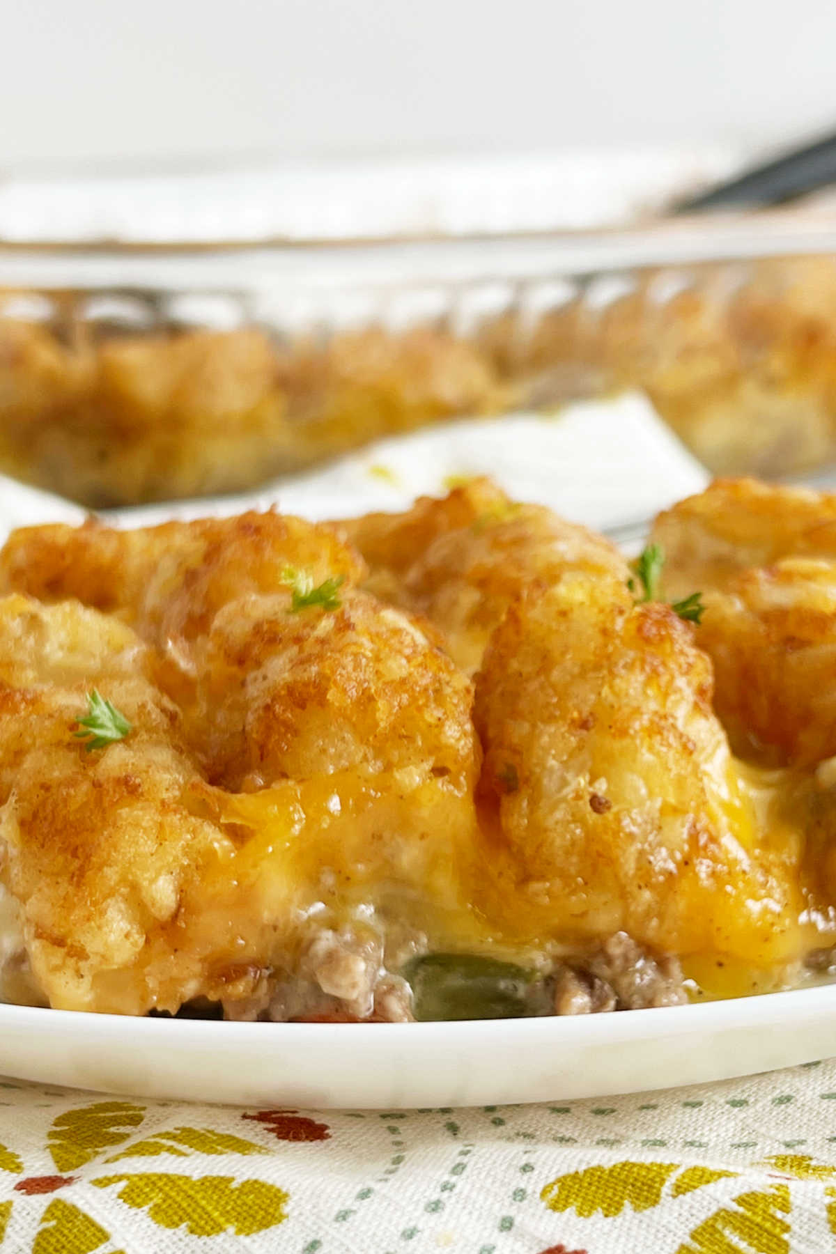 cheesy tater tot casserole with crispy tater tots and melted cheese on a plate