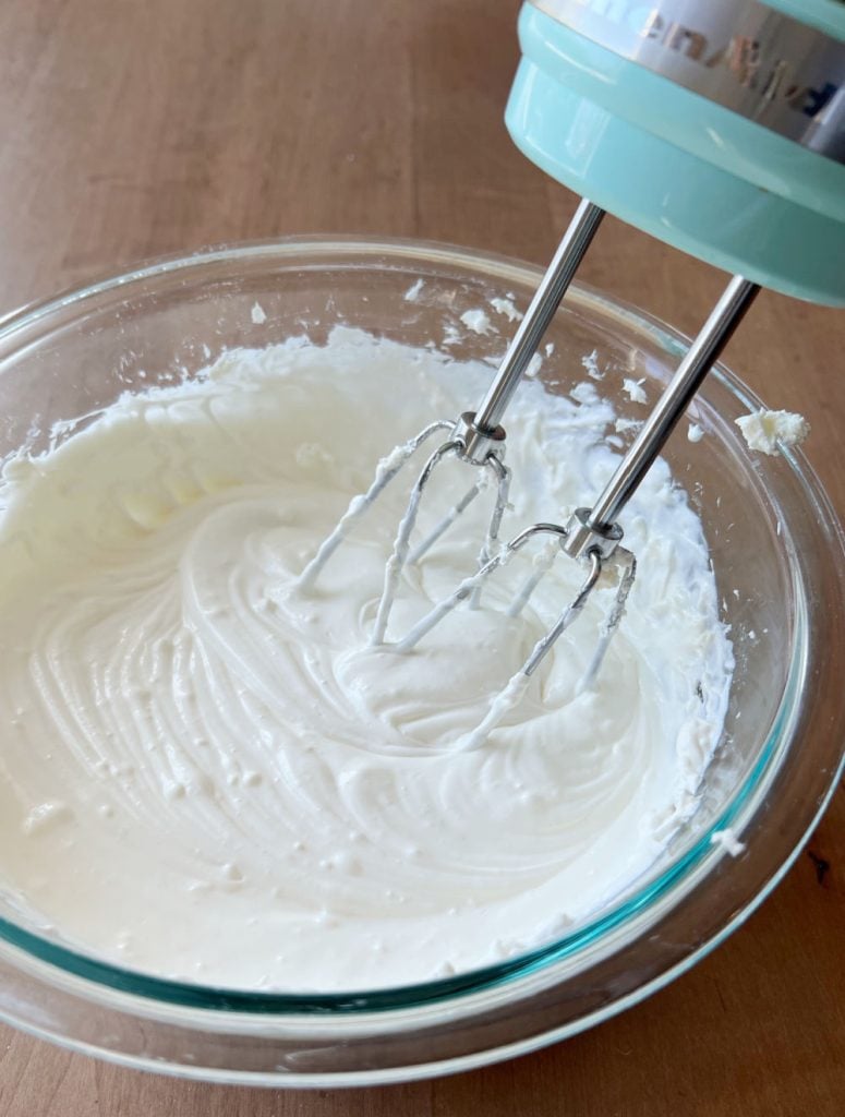 blend sour cream and cream cheese with electric mixer in mixing bowl