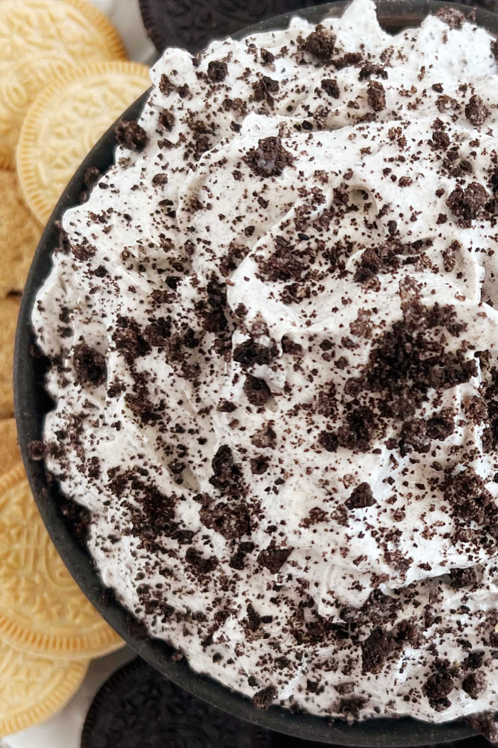 close up of oreo dip with crushed oreo cookies on top