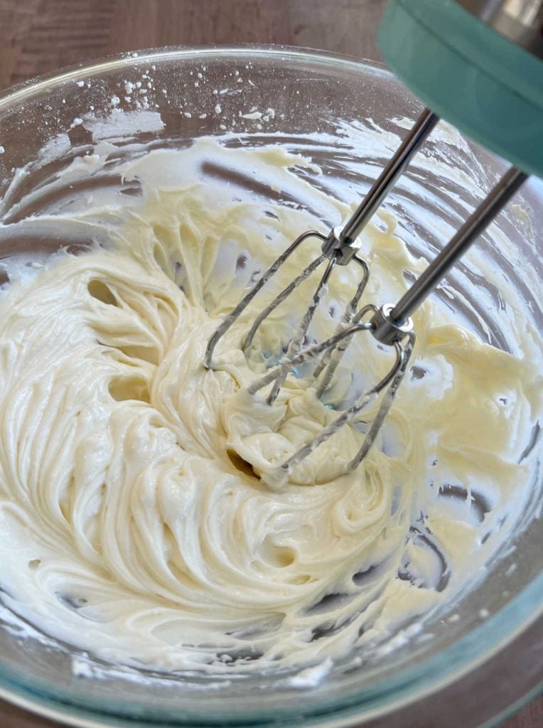 beat cream cheese and vanilla in mixing bowl with electric mixer