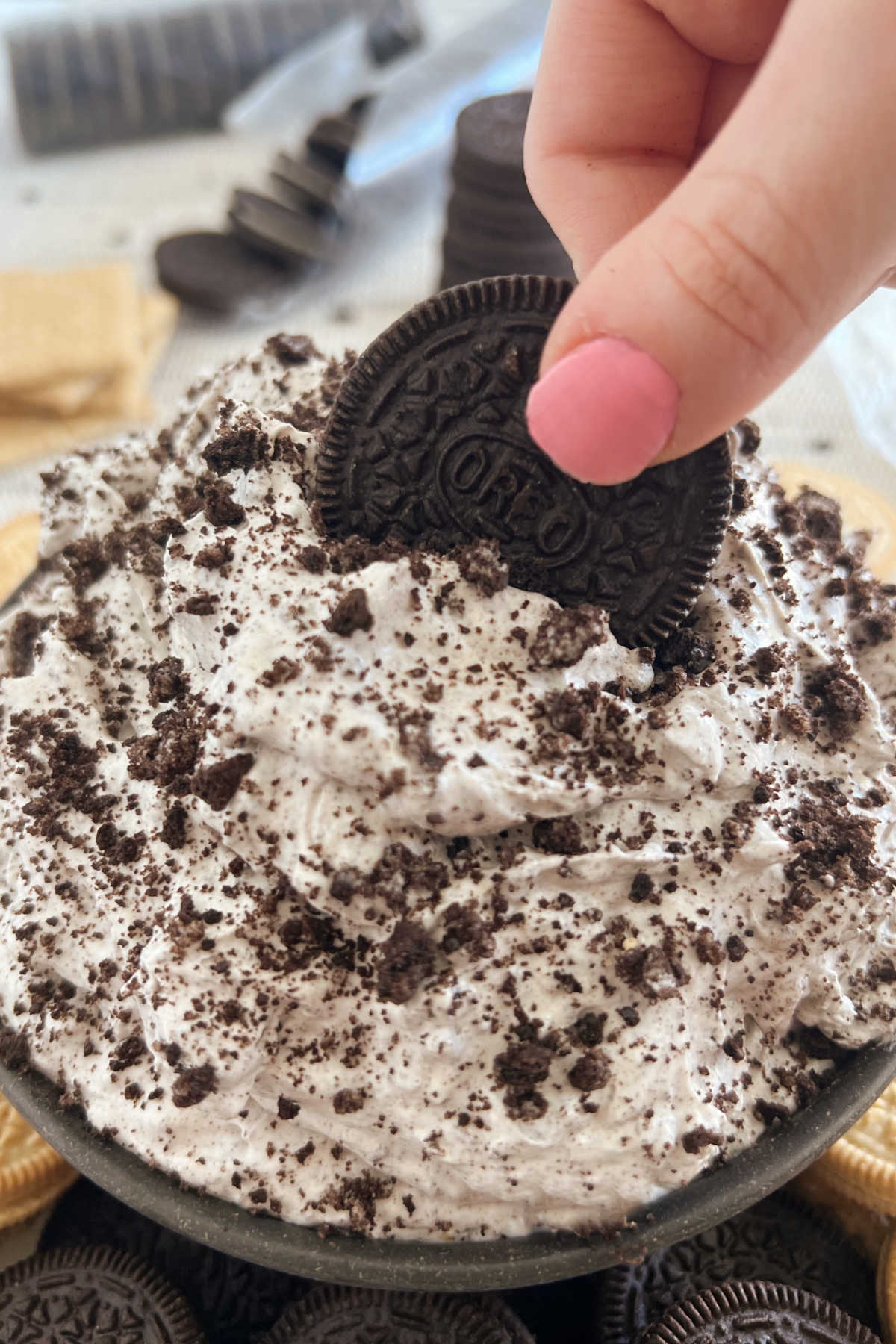 dip Oreo cookie into Oreo cookies and cream dip