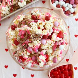 Valentine Day snack mix with popcorn and Valentine's Day candy on the table