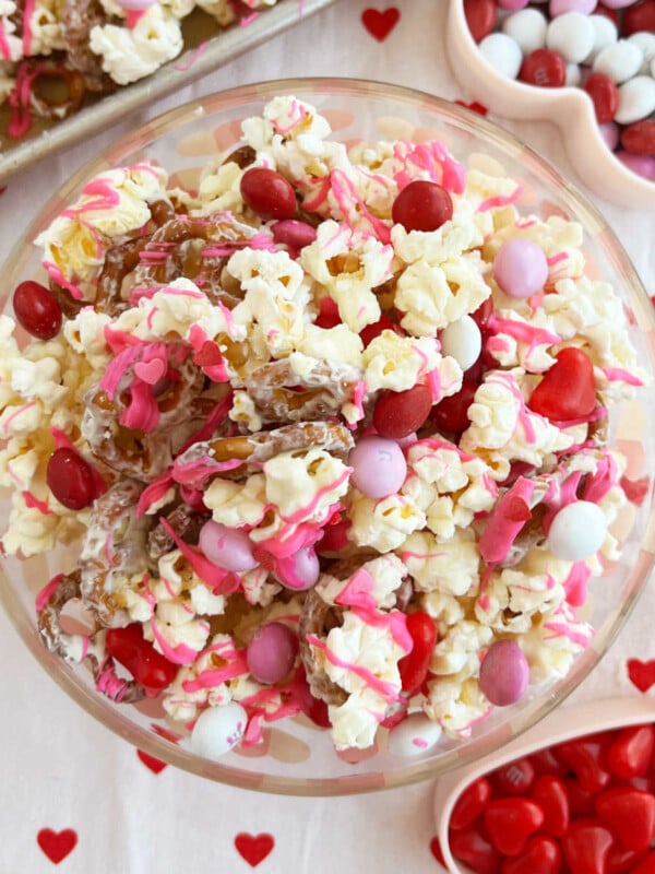 Valentine Day snack mix with popcorn and Valentine's Day candy on the table