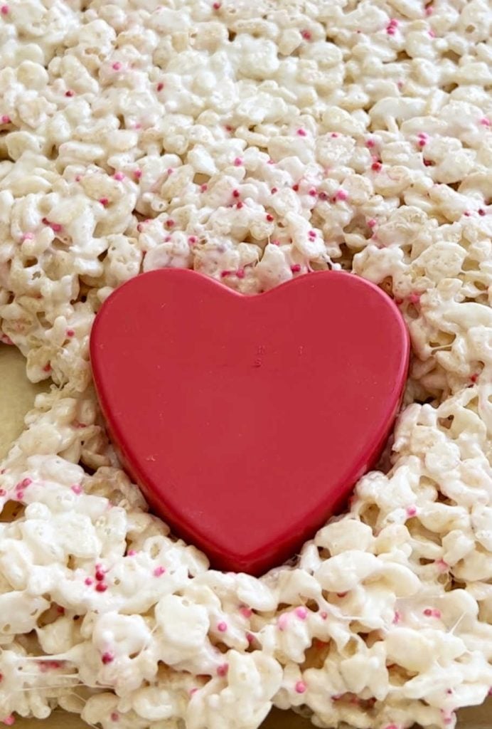 cut heart shape from rice krispie treats with heart cookie cutter
