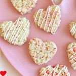 heart shaped Valentine Rice Krispie treats with sprinkles on a pink plate