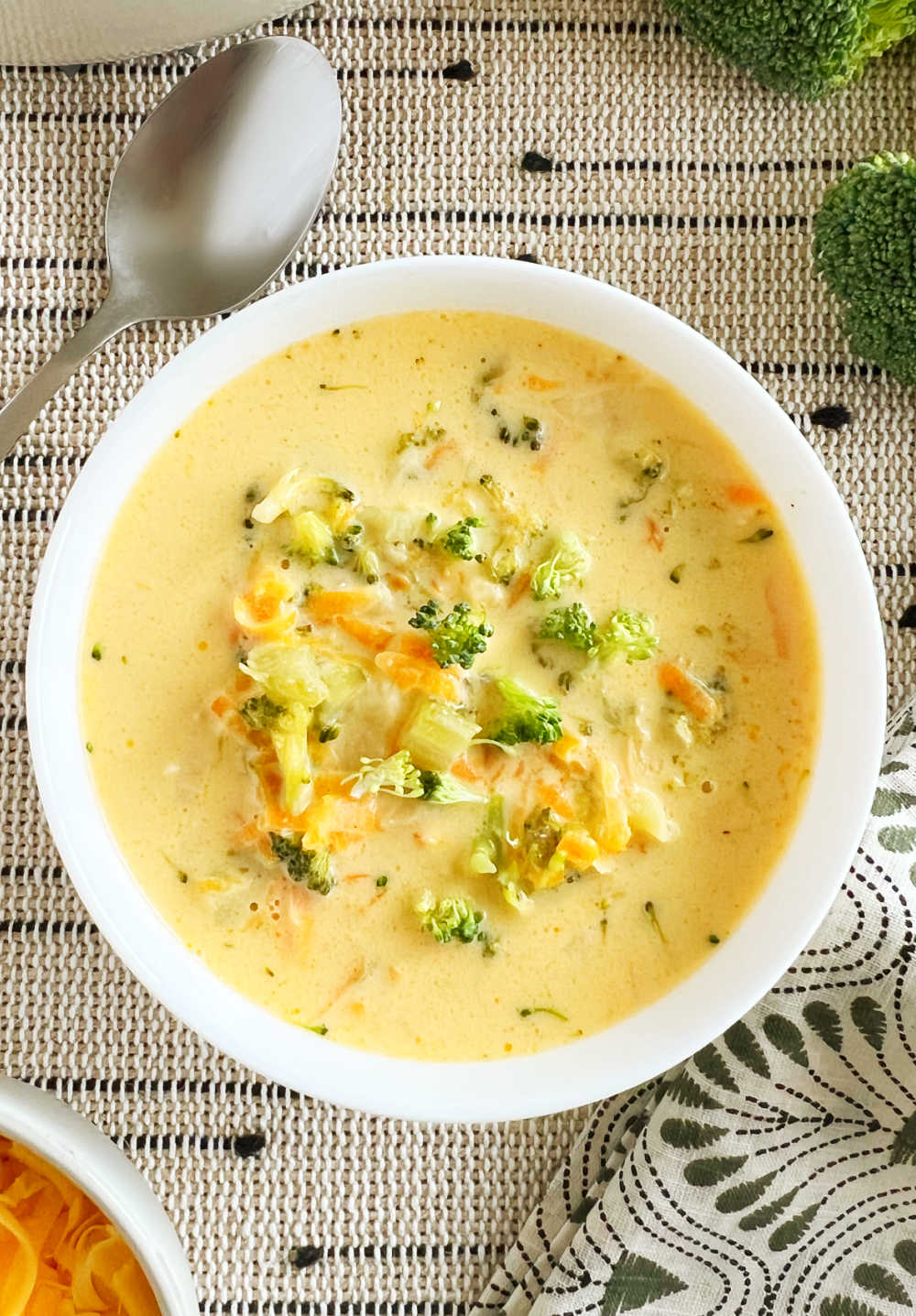 close up of easy broccoli cheddar soup in white bowl