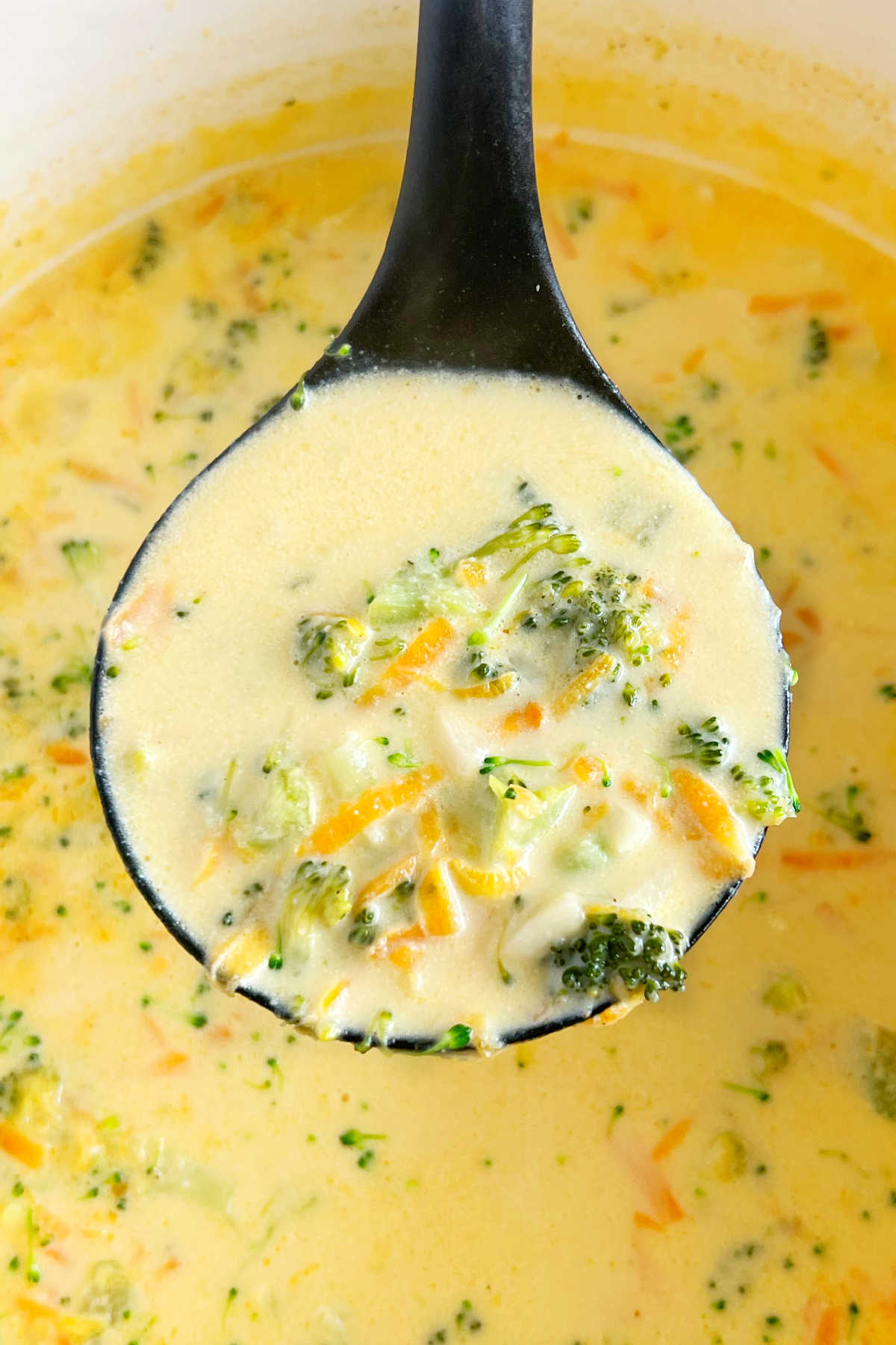 creamy broccoli cheddar soup in ladle