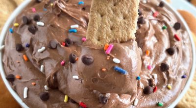 brownie batter dip with mini chocolate chips and sprinkles on graham cracker