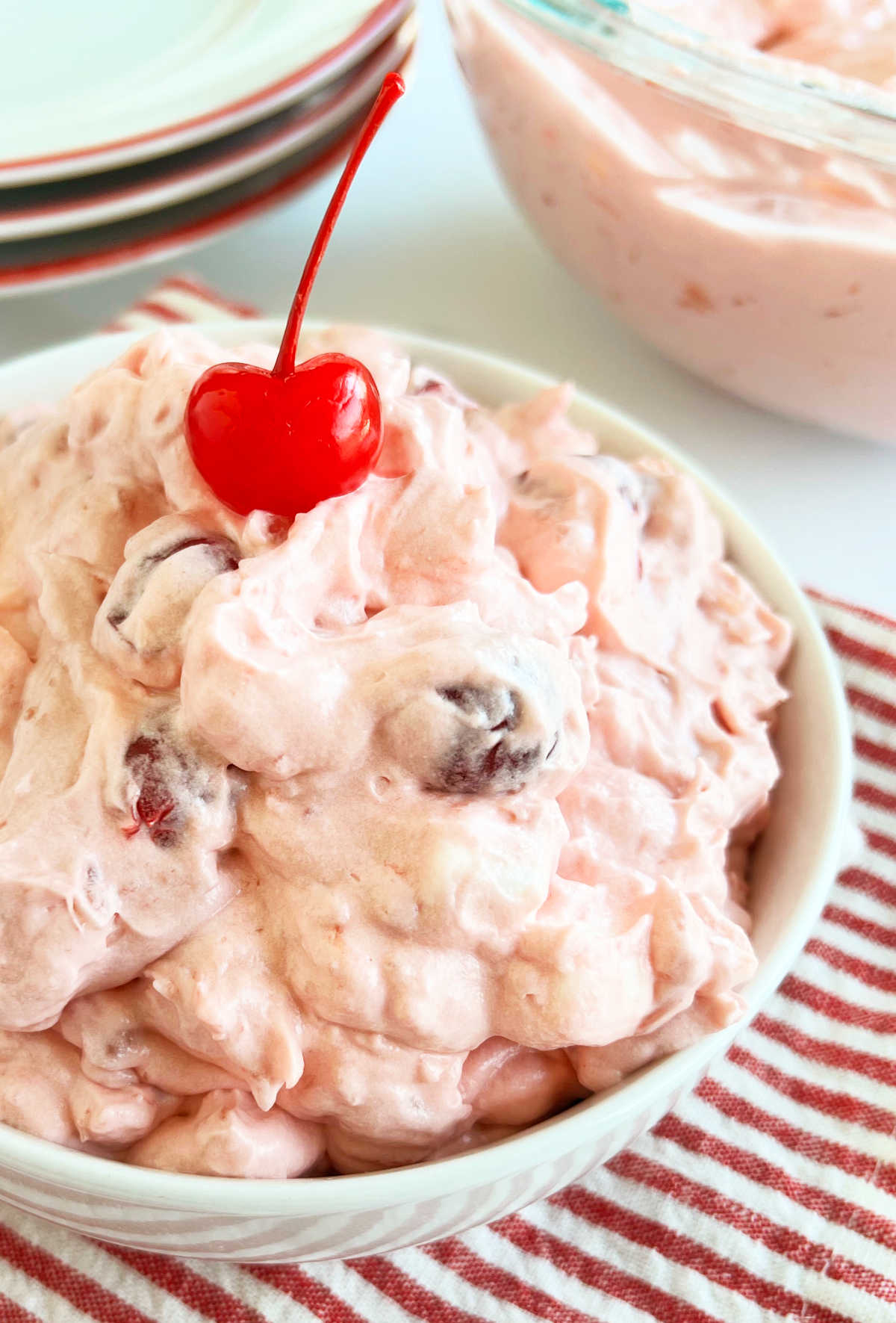 bowl of pink fluff salad with cherries and marshmallows