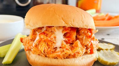 crock pot buffalo chicken sandwiches with ranch dressing and celery sticks