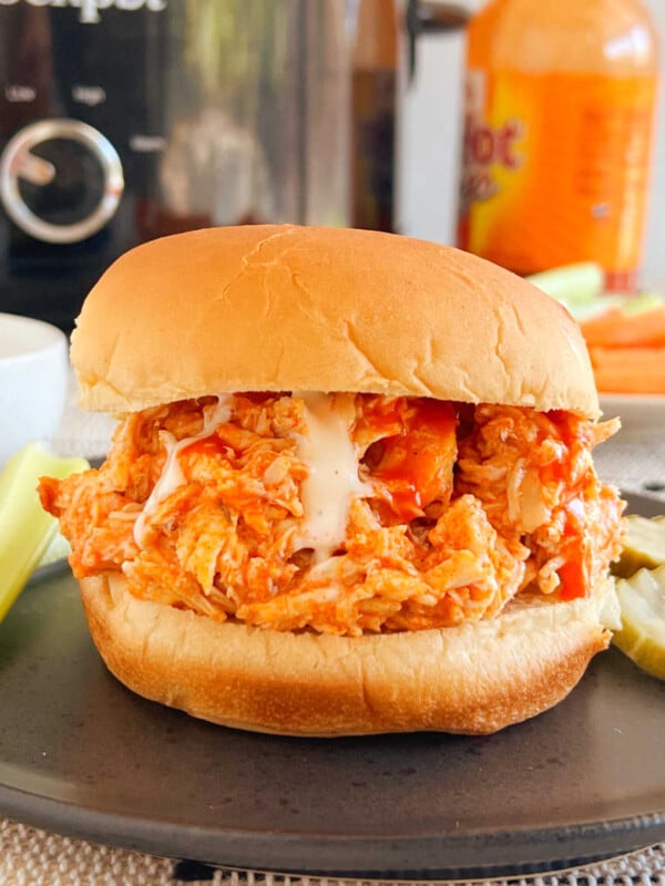 crock pot buffalo chicken sandwiches with ranch dressing and celery sticks