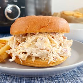 crock pot chicken bacon ranch sandwiches ( crack chicken )on a plate with french fries