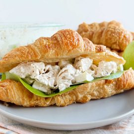 lemon chicken salad recipe in a croissant roll with lettuce