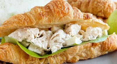 lemon chicken salad recipe in a croissant roll with lettuce