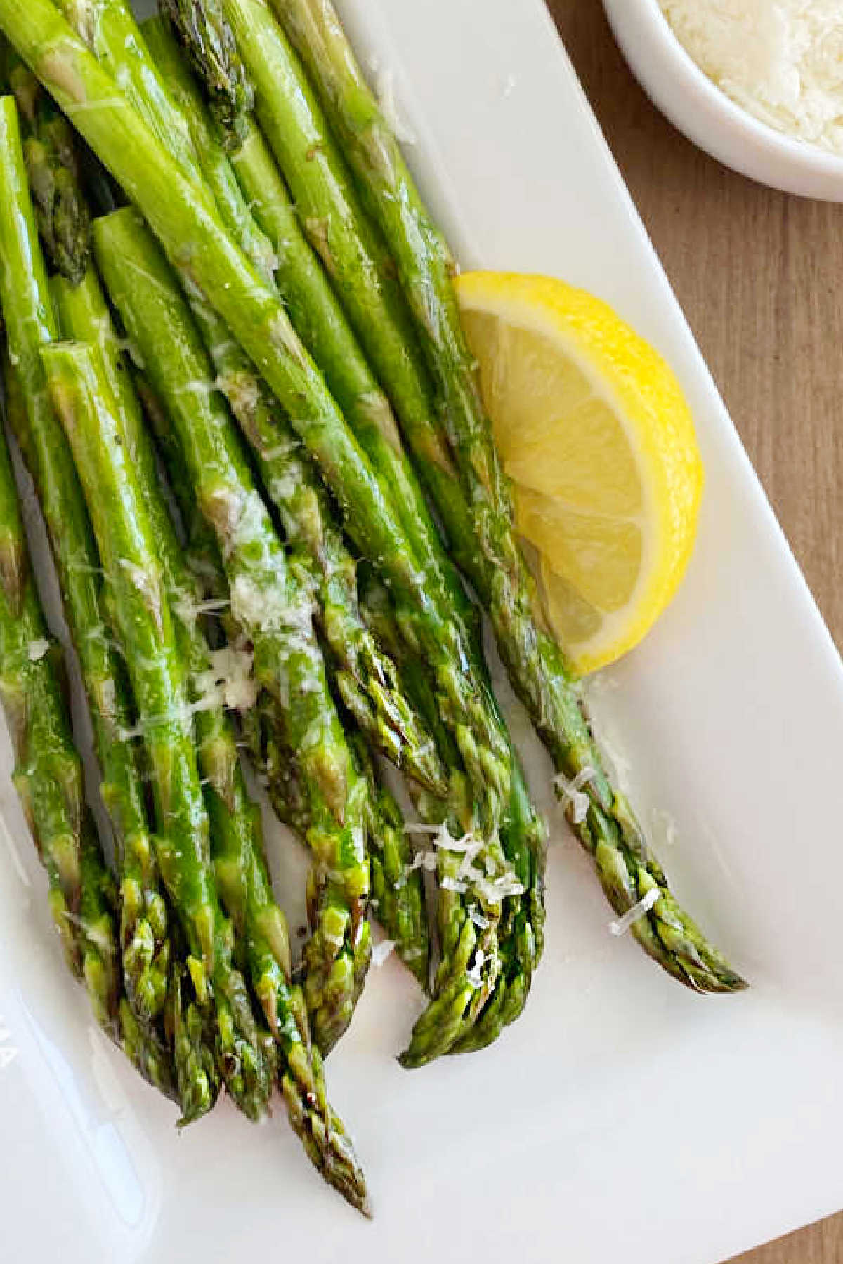 microwave asparagus with Parmesan cheese and lemon on platter