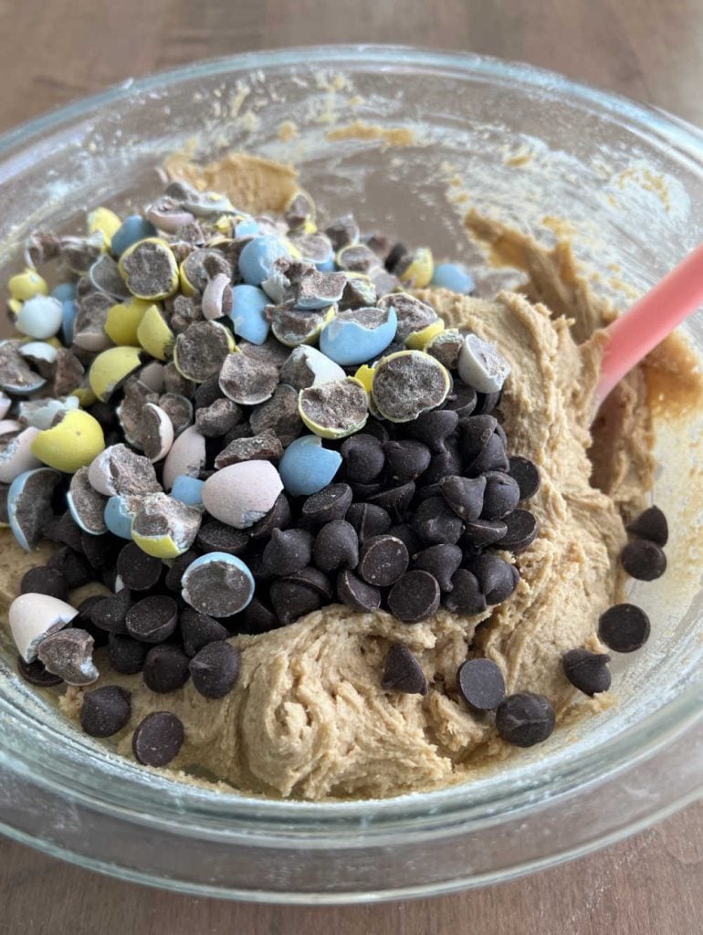 mix chocolate chips and chocolate eggs into cookie dough