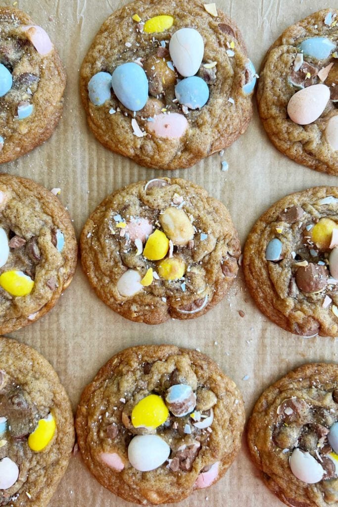 baked Easter egg cookies on parchment paper cookie sheet