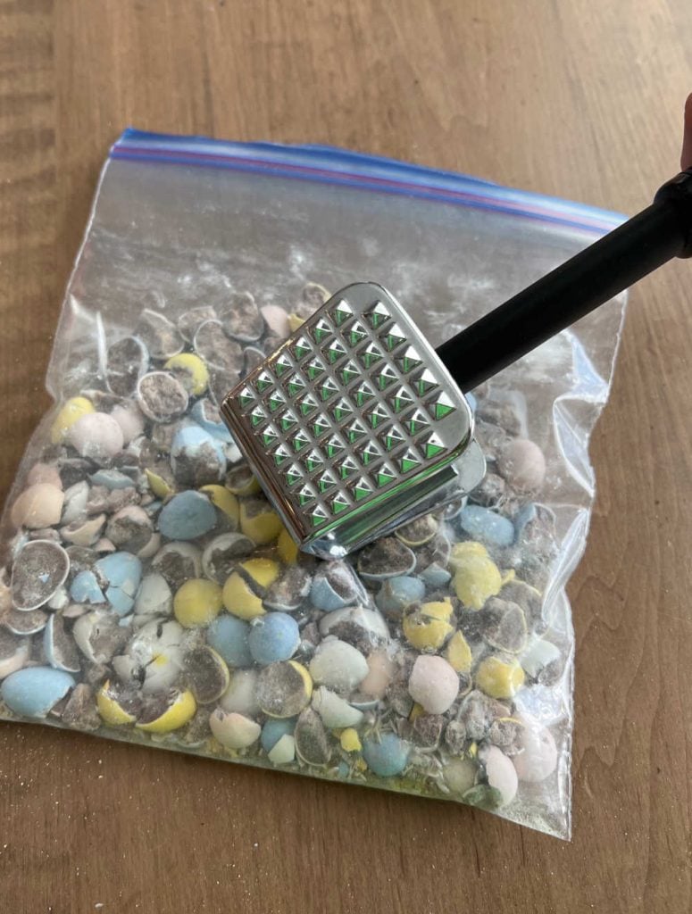 crush mini egg candy with mallet