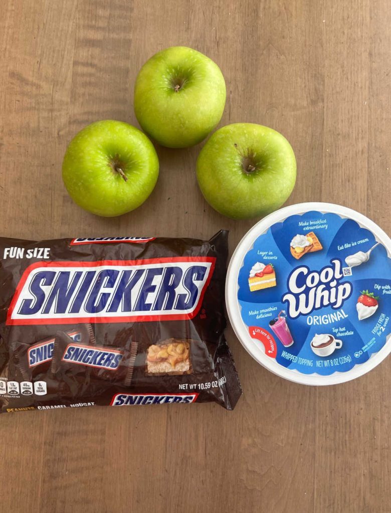 Granny Smith apples, Cool Whip and bag of Snickers candy bars