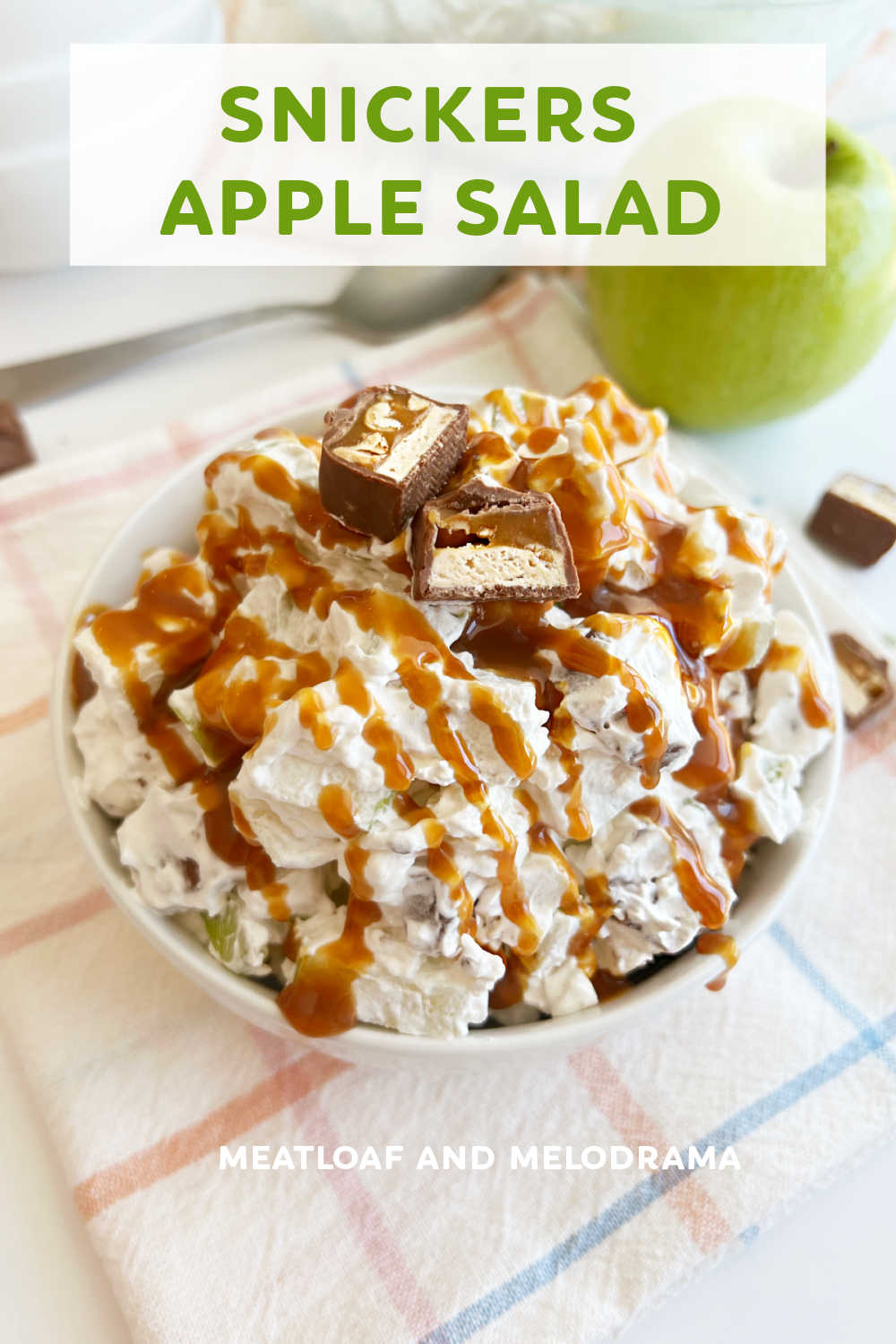 Snickers Apple Salad is an easy recipe for dessert salad made with tart apples, Cool Whip and Snickers candy bars. Only 3 ingredients in this simple side dish and perfect for holidays, family gatherings and potluck dinners! via @meamel